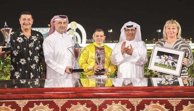 Qatar Racing and Equestrian Club (QREC) Racing manager Abdulla Rashid al-Kubaisi (second from right) with the winners of the Halul Island Cup after Sraab won the 2400m race on turf at the Al Rayyan Park yesterday. PICTURES: Juhaim