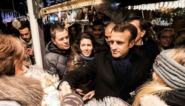 French President Emmanuel Macron (C) meets people as he visit the Christmas market in Strasbourg on December 14, 2018 as he came to pay tribute to the victims of the December 11 attack who killed four people