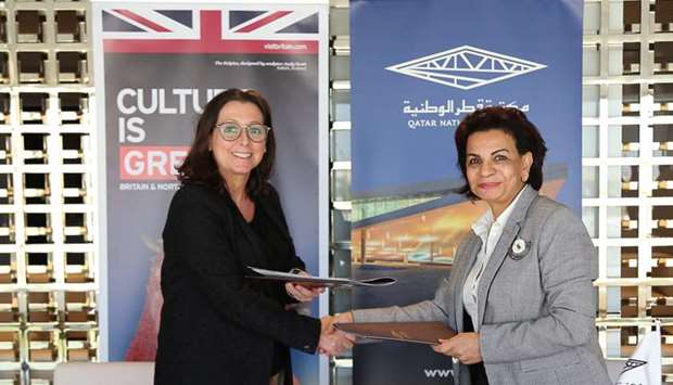 Dr. Sohair Wastawy, Executive Director of Qatar National Library, and Sam Ayton, Director of the British Council in Qatar, shake hands after signing the MoU