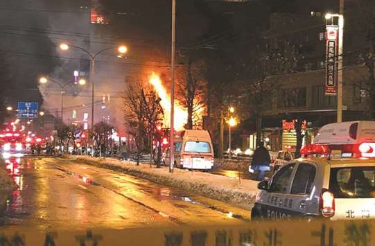 Fire rages at the site of an explosion at a bar in Sapporo, Japan.