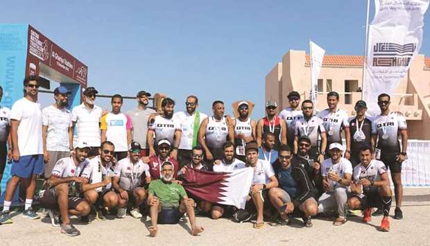 Winners of the second leg of the Qatar National Triathlon Series pose with their medals.