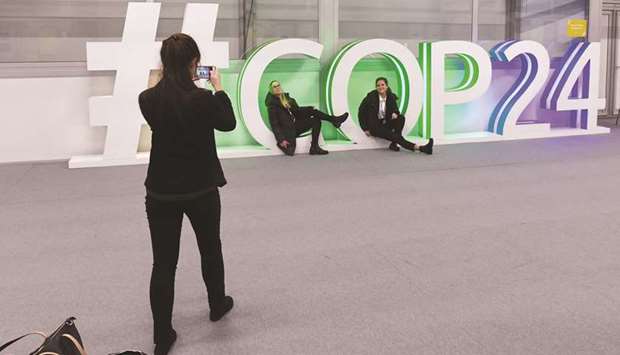Participants pose for a picture during the final session of the COP24 summit on climate change in Katowice.