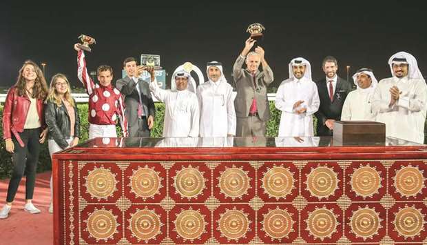 HE Minister of Culture and Sports Salah bin Ghanem bin Nasser al-Ali (centre), Qatar Racing and Equestrian Club (QREC) chairman Issa al-Mohannadi (fourth from right), QREC CEO Nasser Sherida al-Kaabi (right) and Turkish actor Cemal Hunal (third from right) pose with the winners of the The Late Sheikh Jassim Bin Mohammed Al Thani Trophy - Qatar National Day Trophy (Gr2 Pa) yesterday. PICTURES: Juhaim