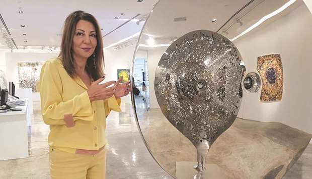 Ghada Sholy with one of the sculptures by Nadim Karam, Lebanon, from the current exhibition, u2018Memory Lapse.u2019  PICTURES: Joey Aguilar