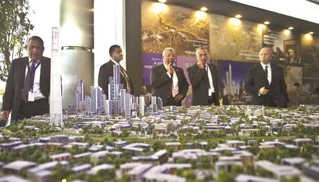 A delegation looks at a scale model of the new Egyptian capital displayed at the congress hall in the Red Sea resort of Sharm El-Sheikh on March 14, 2015. Failure to reach an agreement on a $20bn development in the new administrative capital will raise questions over Egyptu2019s ability to attract crucial foreign direct investments to propel economic growth.