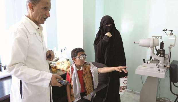 A child patient is checked by an ophthalmologist in Sanaa.