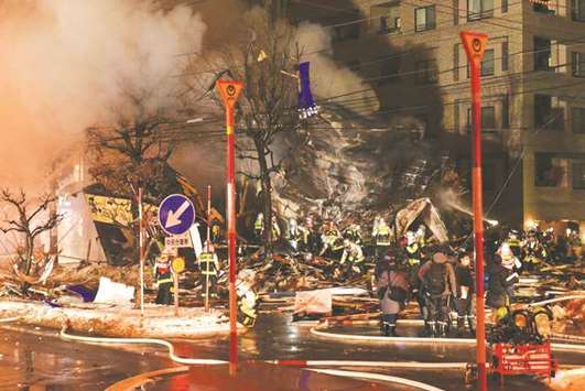 Firefighters carry on rescue works after an explosion at a restaurant in Sapporo, in the northern Hokkaido prefecture on Sunday. Dozens have been injured and no casualties have been reported.