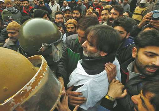 Police try to detain Mohamed Yasin Malik, chairman of Jammu Kashmir Liberation Front (JKLF) during a protest march in Srinagar yesterday.