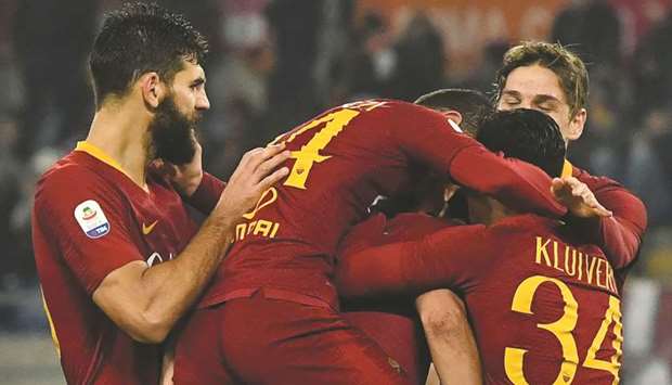 AS Roma Argentine defender Federico Fazio (left) and his teammates congratulate Justin Kluivert (right) for scoring against Genoa during their Italian Serie A match at the Olympic stadium in Rome. (AFP)