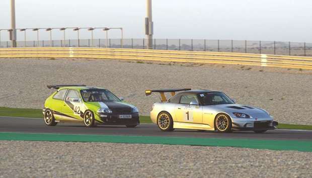 Abdulla al-Khelaifi and Ahmed al-Asiri in action during the second round of the Qatar Touring Car Championship at the Losail International Circuit.