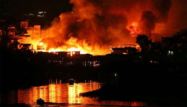 Houses on fire are seen at Educando neighbourhood, a branch of the Rio Negro, a tributary to the Amazon river