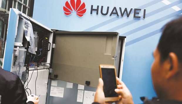 A man takes pictures of an open vending machine at a Huawei promotional stall in Huaqiangbei Commercial Street, a market place for Chinese producers and international wholesale buyers, in Shenzhen, Guangdong province. The Chinese telecom giant has faced a tough year as western countries like the United States, Australia, New Zealand, Britain, pull back from using its products while concerns grow in Japan, France, Germany and even the Czech Republic over security issues.