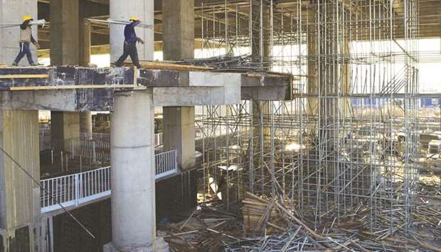 Workers are seen at a construction site of the Zhangjiakou South railway station in Hebei province. Chinau2019s aggregate economic policy will be moderately loose next year to maintain steady growth,u201d said Du Feilun, director of the Institute of Economic Research at the National Development and Reform Commission, who expects more measures to ramp up infrastructure investment, boost consumption and lower costs businesses face.