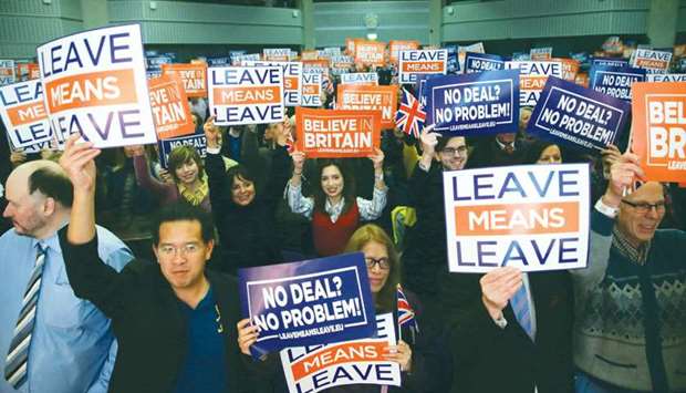 TOPSHOT - Attendees hold up signs with slogans at a political rally organised by the pro-Brexit u2018Leave Means Leaveu2019 campaign group in central London on December 14, 2018. The Leave Means Leave group, supported by political figures like ERG chairman Jacob Rees-Mogg and former Ukip leader Nigel Farage, held a political rally to u201cSave Brexitu201d as the latest Brexit summit in Brussels leaves Theresa May facing a dwindling number of options over Britainu2019s exit from the EU.