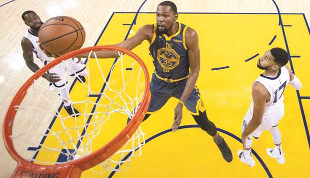 Golden State Warriors forward Kevin Durant shoots the basketball as Memphis Grizzlies guard Garrett Temple (right) and forward Jaren Jackson Jr. look on during the first-half of their NBA game at Oracle Arena. PICTURE: USA TODAY Sports