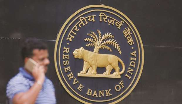 A man speaks on his mobile phone outside the Reserve Bank of India headquarters in Mumbai. The RBI revised its inflation projections downwards to 2.7%-3.2% by March, from 3.9%-4.5% two months back, and expects it to stay within 4.2% by September 2019.