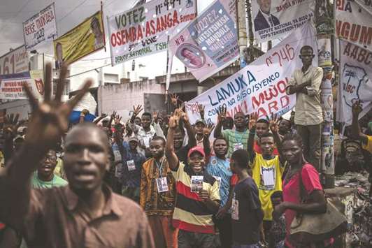 Supporters of Democratic Republic of Congo opposition leader Martin Fayulu gesture number four (the candidate number on the electoral list) as they demonstrate on a crossroad in the popular Ndjili district of Kinshasa yesterday, after campaigning was called off by the authorities on security grounds.