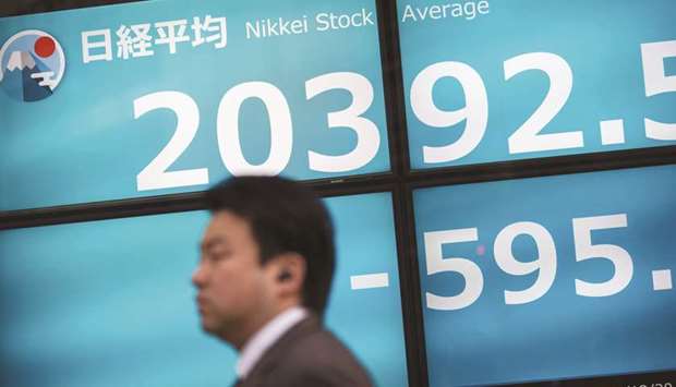 Asian markets slump after Fed hikes rates