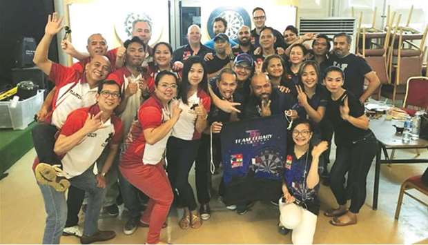 Last Samurai and Legacy darts teams celebrate after their respective wins in the week 11 of the Doha Darts League.