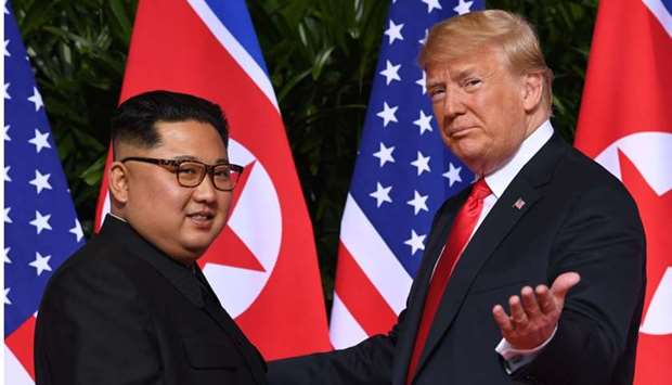 In this file photo taken on June 11, 2018 US President Donald Trump (R) gestures as he meets with North Korea's leader Kim Jong Un (L) at the start of their historic US-North Korea summit, at the Capella Hotel on Sentosa island in Singapore