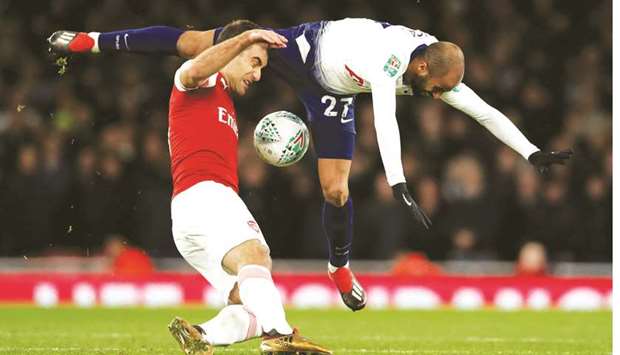 Arsenalu2019s Sokratis Papastathopoulos (left) and Tottenhamu2019s Lucas Moura vie for the ball during the League Cup quarter-finals in London on Wednesday night. (Reuters)