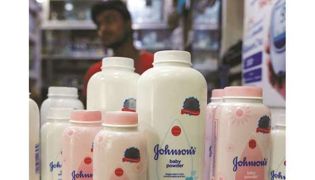 A shopkeeper displays bottles of Johnson & Johnson baby powder at a medical store in Kolkata yesterday.