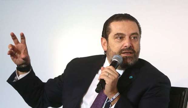 Lebanese Prime Minister-designate Saad al-Hariri gestures as he speaks during a conference in Beirut