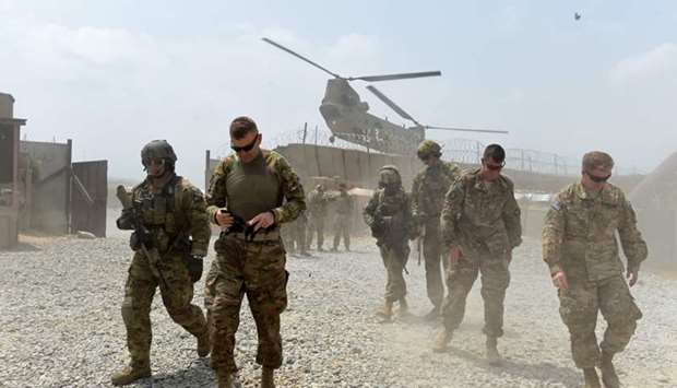 In this file photo taken on August 12, 2015 US army soldiers walk as a NATO helicopter flies overhead at coalition force Forward Operating Base (FOB) Connelly in the Khogyani district in the eastern province of Nangarhar