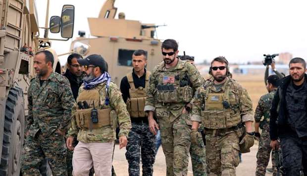 Syrian Democratic Forces and US troops are seen during a patrol near Turkish border in Hasakah, Syria November 4, 2018
