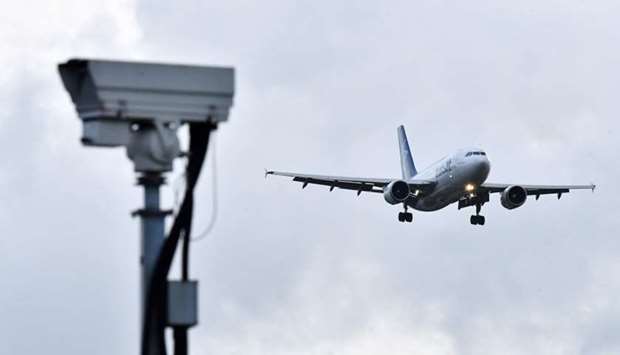 An Air Transat aircraft is pictured beyond a CCTV camera as it prepares to land at London Gatwick Ai