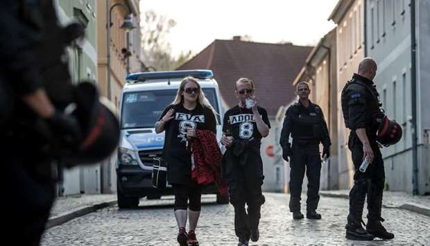 Participants of the neo-Nazi festival 'Shield and Sword Festival' wearing shirts with symbols connected with nazi as they walk in downtown of Ostritz, Germany, 21 April 2018. More than 1,000 participants from Germany, Poland and Czech Republic gathered to attend the two-day neo-Nazi festival to mark the birthday of Nazi dictator Adolf Hitler on 20 April, 2018. EPA