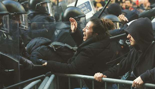 Members of the Catalan regional police force Mossos du2019Esquadra try to keep protesters behind crowd control barricades during scuffles at a Catalan pro-independence demonstration yesterday in Barcelona as the Spanish cabinet held a meeting in the city.