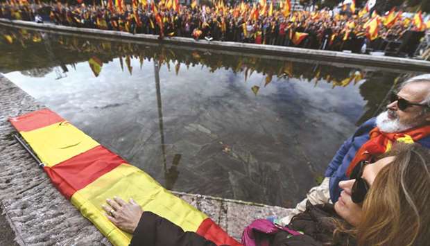 People attend a demonstration in Madrid, called by the far-right party VOX against Catalan separatists.