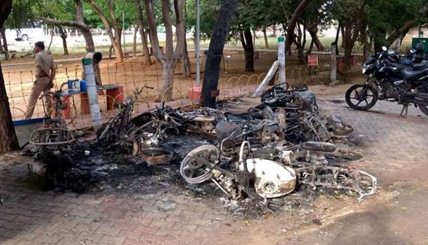 FILE PHOTO: Charred vehicles are pictured near a government office, after at least 13 people were killed when police fired on protesters seeking closure of plant on environmental grounds in town of Thoothukudi