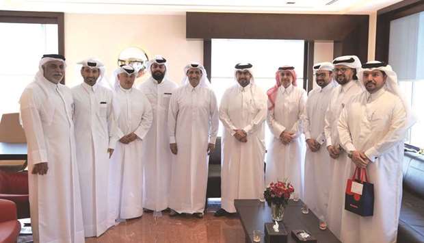 Ooredoo Chairman Sheikh Abdulla bin Mohamed bin Saud al-Thani and other senior executives with Esu2019hailSat CEO, Ali bin Ahmed al-Kuwari, and a group of Esu2019hailSat team members.