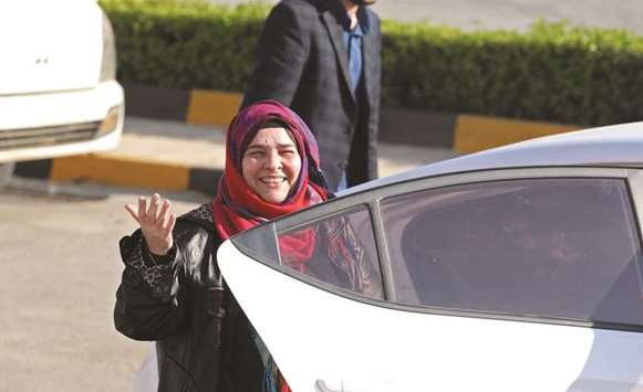 Nancy Roxana Papa waves at the Bab al-Hawa crossing with Turkey ahead of being handed over to Turkish authorities.