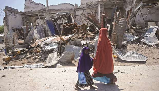 Somalis gather near the wreckage of a car involved in the explosion near the presidentu2019s residence.