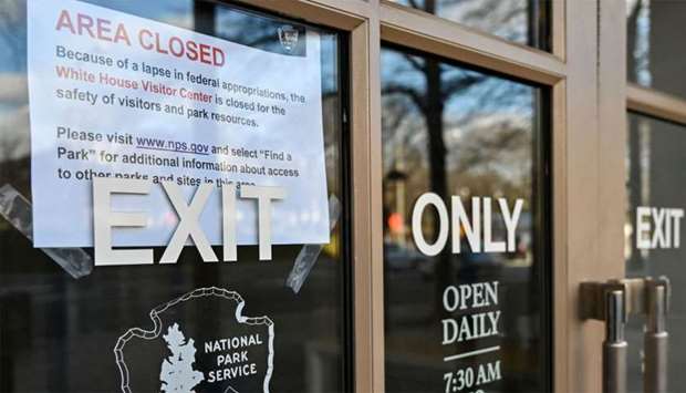 A sign is displayed on a government building that is closed because of a US government shutdown in Washington, DC. The partial US government shutdown is set to stretch on through Christmas as the Senate adjourned with no deal to end it in sight.