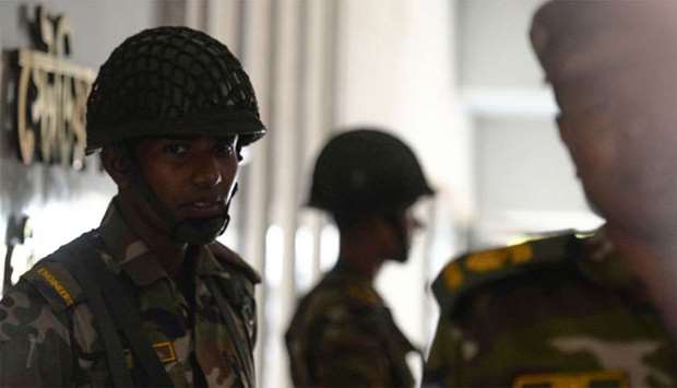Bangladesh Army soldiers stand guard at a temporary base set up in Dhaka