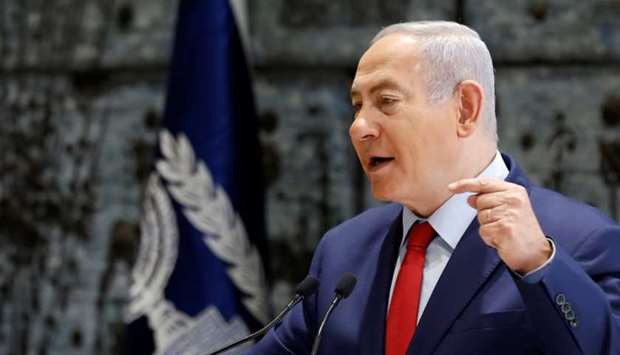 Israeli Prime Minister Benjamin Netanyahu gestures as he speaks during a ceremony whereby Amir Yaron is sworn in as Bank of Israel governor, in Jerusalem