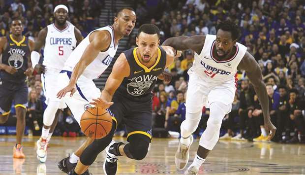 Golden State Warriors guard Stephen Curry drives in against LA Clippers guard Patrick Beverley (right) during the third quarter at Oracle Arena. PICTURE: USA TODAY Sports