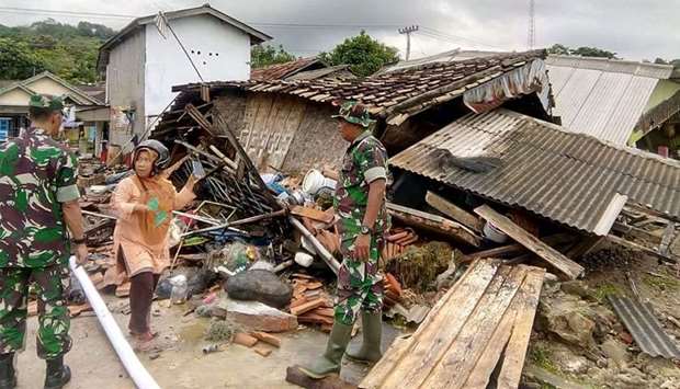 Indonesia\'s Badan Nasional Penanggulangan Bencana (BNPB), the accident mitigation agency, shows rescuers searching for victims amongst buildings damaged from the tsunami in Carita, Banten province