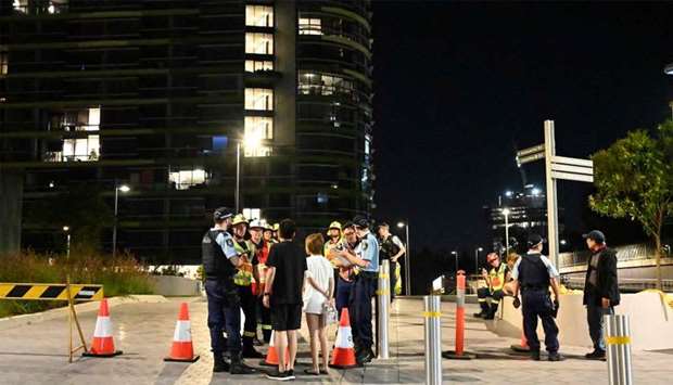 Police check the unit numbers of the residents after an inspection of the Opal Tower by firefighters and engineers in Sydney