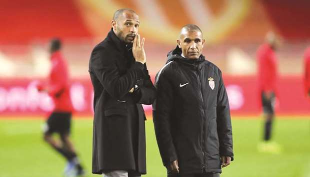 Monacou2019s head coach Thierry Henry (left) talks with his assistant Franck Passi before the defeat to Guingamp last week. (AFP)