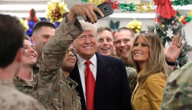 US President Trump and the First Lady greet military personnel at the dining facility during an unannounced visit to Al Asad Air Base, Iraq