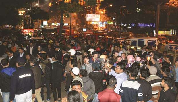 Commuters and onlookers gather outside an exit of Maidan Metro station after a fire broke out inside a carriage along the Line 1 of the Kolkata Metro, in Kolkata yesterday.