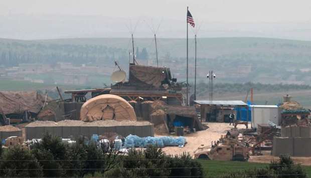 Vehicles and structures of the US-backed coalition forces are seen on the outskirts of the northern Syrian town of Manbij on December 26