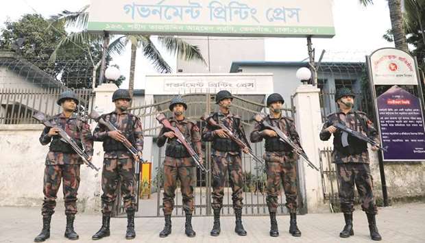 Members of the Border Guard Bangladesh (BGB) stand guard in front of Government Printing Press in Dhaka.