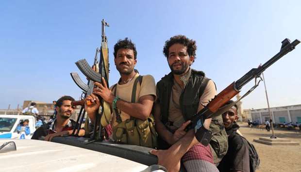 Houthi militants ride on the back of a truck as they withdraw, as part of a UN-sponsored peace agreement signed in Sweden earlier this month, from the Red Sea city of Hodeidah