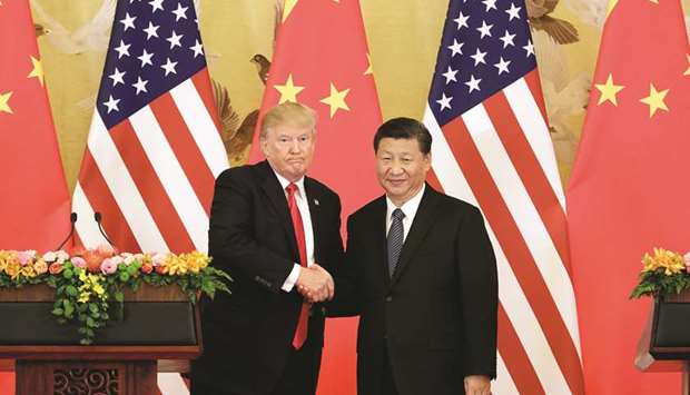 US President Donald Trump and Xi Jinping, Chinau2019s President, shake hands during a news conference at the Great Hall of the People in Beijing on November 9, 2017. The two presidents spoke at length by telephone on Saturday, with each expressing satisfaction with trade talks initiated after their meeting earlier this month in Argentina.